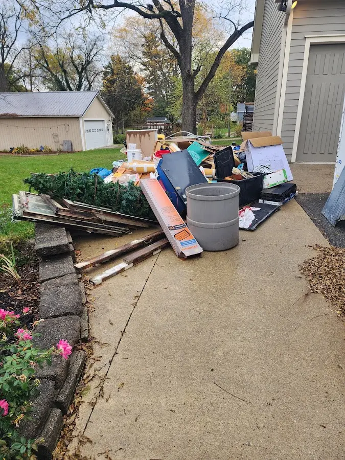 Dumpster being loaded with debris for Roofing Dumpster Rental in Saranac